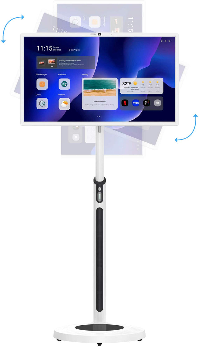 The image features a computer monitor on a stand, with the time displayed as 11:15. The monitor is turned on, and the screen is showing the time and date. The stand is white, and the monitor is placed on top of it. The image also shows a clock in the background, indicating the time of 11:15.