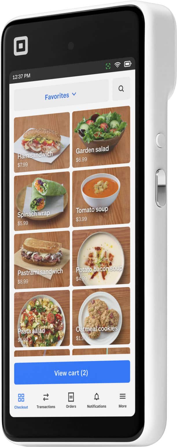 The text on the image reads:

12:37 PM Favorites Ham sandwich $7.99 Garden salad $6.99 Spinach wrap $5.99 Tomato soup $3.99 Pastrami sandwich $8.99 Potato bacon soup $4.99 Pasta salad $5.99 90 Oatmeal cookies $1.99 View cart (2) Checkout Transactions Orders Notifications More.